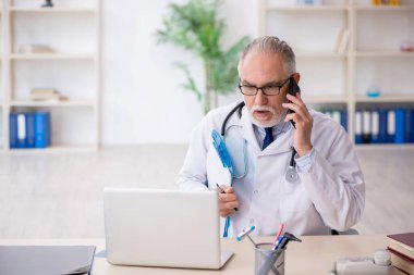 Teletıp konseptinde yaşlı bir doktor.