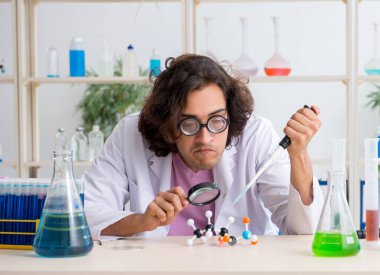 Laboratuvarda çalışan komik erkek kimyager.