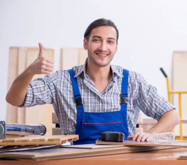 İçeride çalışan genç erkek marangoz.