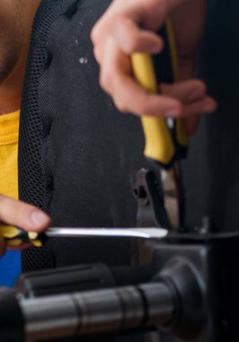 Mobilya tamircisi sandalyeyi tamir etmeye çalışıyor.