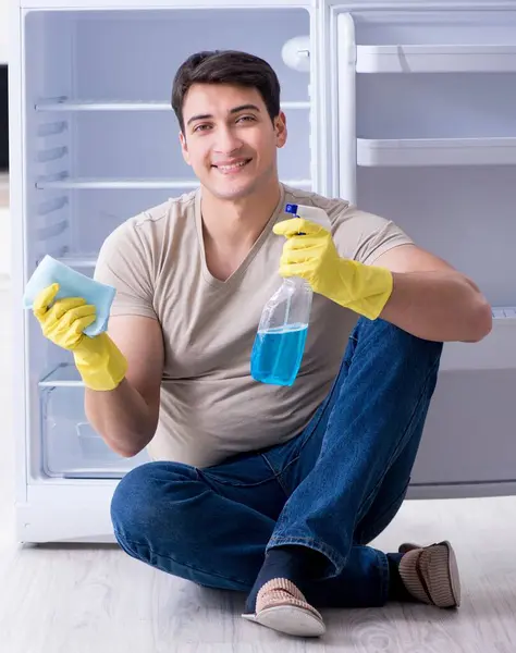 The man cleaning fridge in hygiene concept