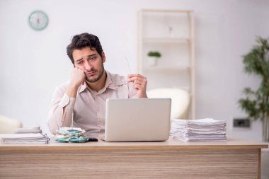 Young accountant sitting at workplace
