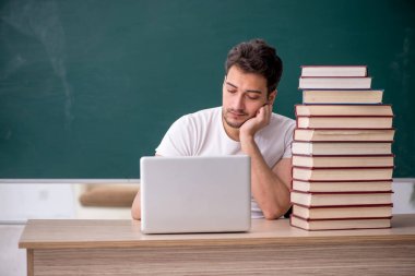 Sınıfta oturan genç öğrenci.