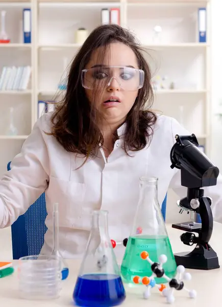 The funny female chemist working in the lab