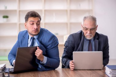 İki çalışan işyerinde oturuyor.