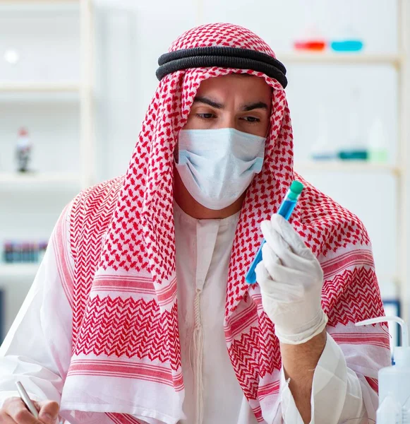 The arab chemist working in the lab office