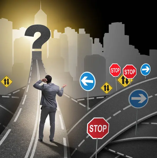 Businessman in uncertainty concept on road intersection crossroads