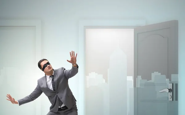 The confused businessman in front of doors