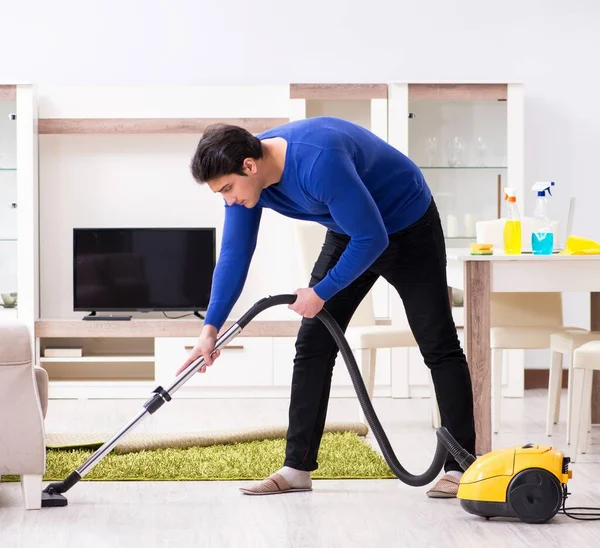 Young Man Vacuum Cleaning His Apartment — Stock Photo, Image