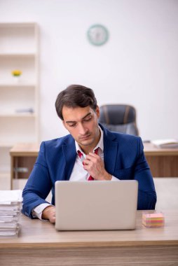 Genç işadamı ve ofiste çok fazla iş var.