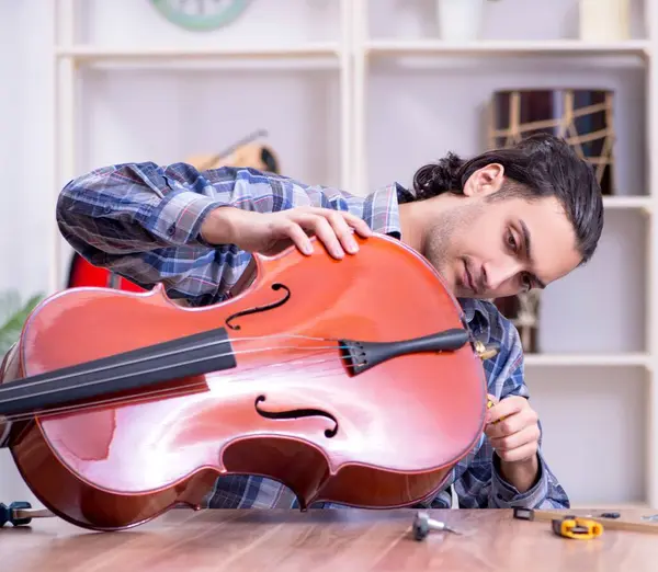 Young Handsome Repairman Repairing Cello — Stock Photo, Image