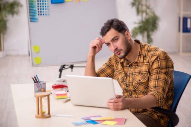 Young designer working at workplace