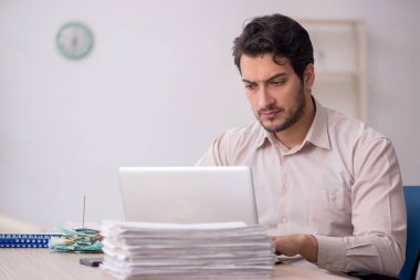 Young accountant sitting at workplace