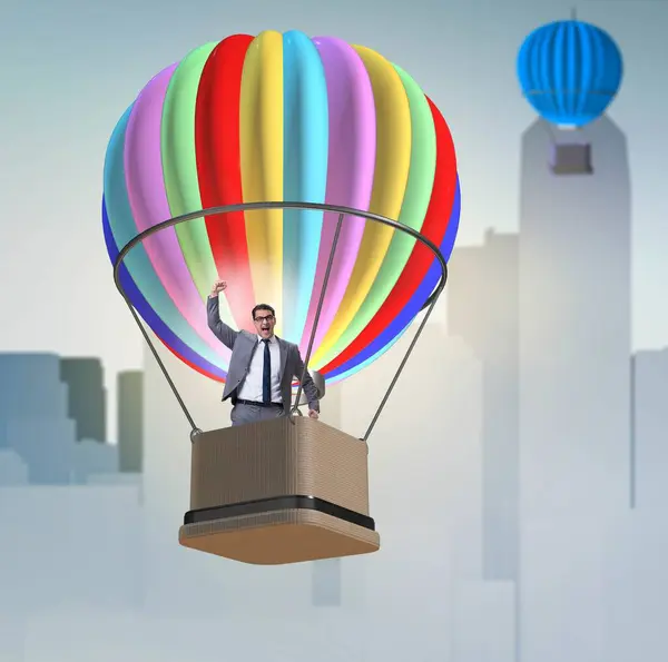 商人乘气球飞行的挑战概念 图库照片