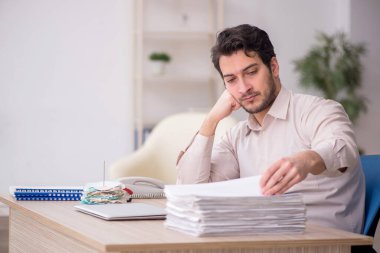 Young accountant sitting at workplace