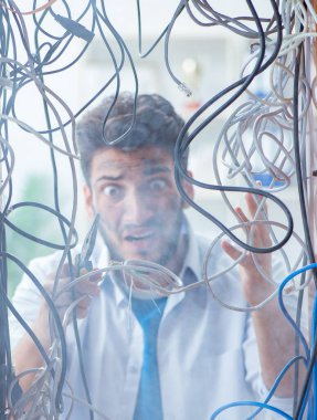 Elektrik teknisyeni tamir konseptinde kabloları çözmeye çalışıyor.