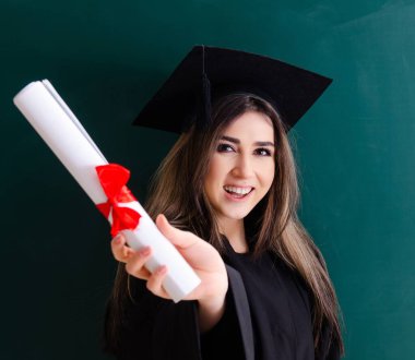 The female graduate student in front of green board