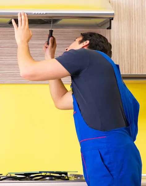 stock image The young service contractor assembling kitchen furniture