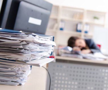 The beautiful female employee unhappy with excessive work