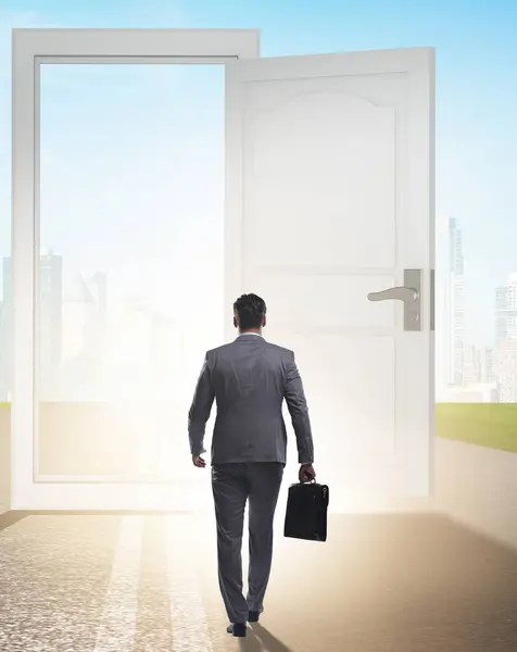 stock image The businessman in front of door in business opportunities concept