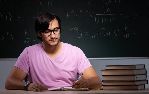 stock image The young male student sitting in classroom