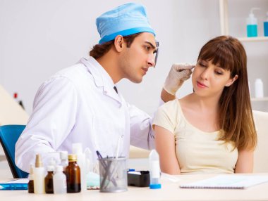 Erkek doktor otolargolog olan genç kadın.