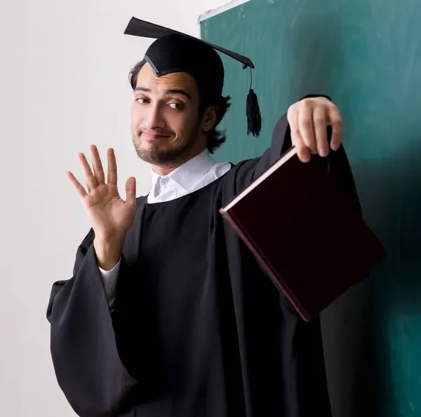 stock image The graduate student in front of green board