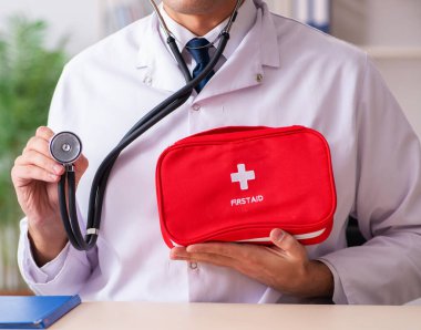 The male doctor with first aid bag