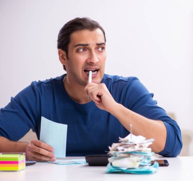 Young man in the budget planning concept clipart