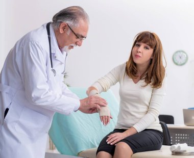 Genç yaralı kadın doktor travmatoloğu ziyaret ediyor.