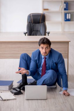 Young employee unhappy with excessive work at workplace