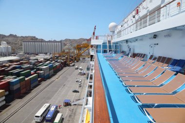 big cruise ship in port in right side of image. embarkation. many cargos in left. clipart