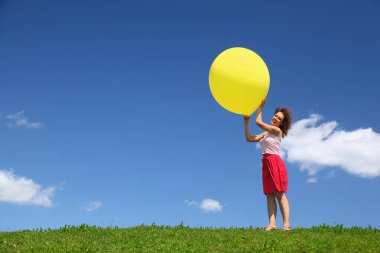 Woman holds  large inflatable ball in hands on wind clipart