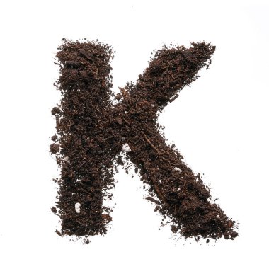 Büyük harf K beyaz arkaplanda izole edilmiş toprak kullanarak oluşturuldu.
