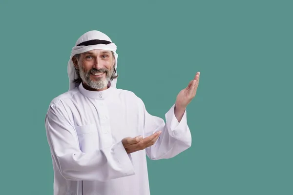 Joyful Arab Man Wearing Dishdasha Traditional Clothing Smiles Points Both — Stock Photo, Image