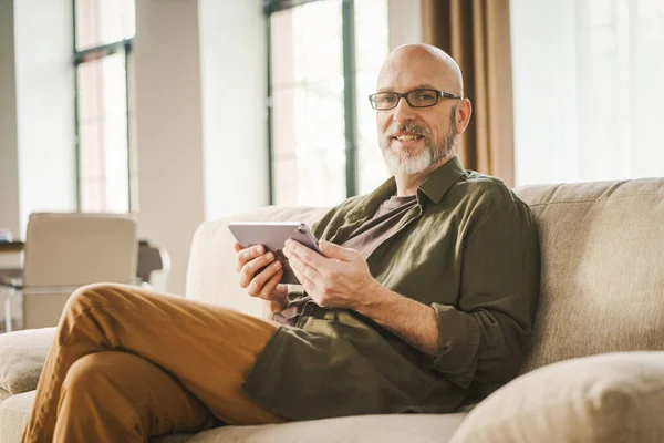 Mutlu Kıdemli Adam Modern Teknolojinin Rahatlığıyla Evde Vakit Geçiriyor Kanepede — Stok fotoğraf