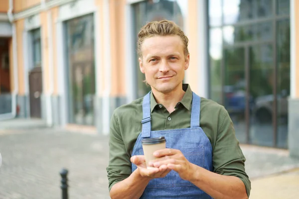 Concept Coffee Waiter Offers Hot Paper Cup Coffee Client Street — Stock Photo, Image