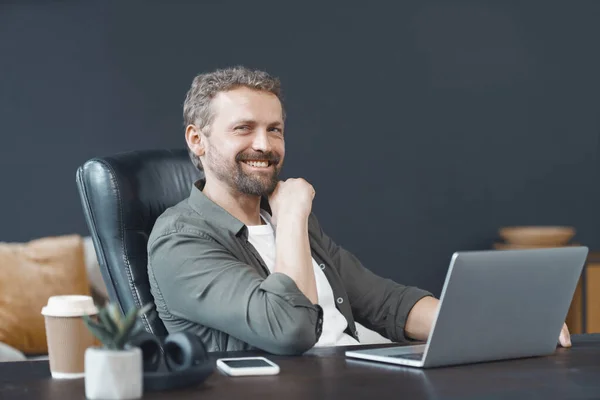 Smiling Man Menemukan Sukacita Dalam Pekerjaan Karena Rajin Mengoperasikan Laptop Stok Foto Bebas Royalti