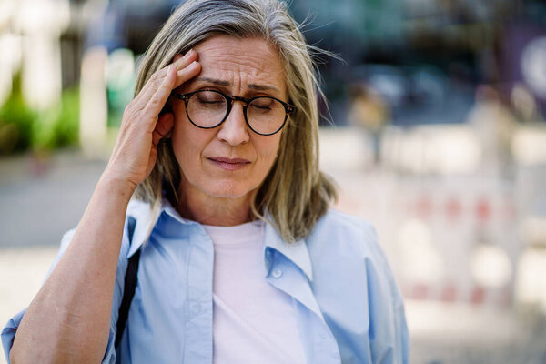 Woman Wearing Glasses Shown Holding Her Head Straightforward Image Royalty Free Stock Images