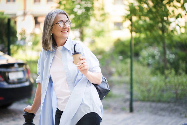 Woman Walking Street Clutching Cup Coffee Her Hand Stock Picture