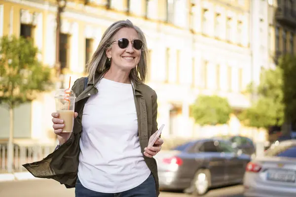 Woman Strolling Busy Street While Carrying Beverage Her Hand Stock Photo