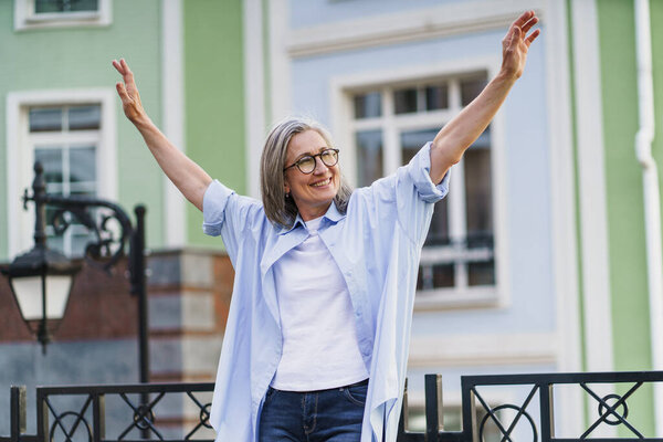 Woman Standing Front Building Arms Outstretched Stock Photo