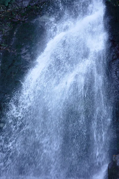 Part of big waterfall toned in blue at dusk