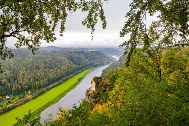 The magnificent and picturesque German river Elbe. Germany. The sandy cliffs of Bastei, 200 meters high above the Elbe River, are a famous tourist attraction.