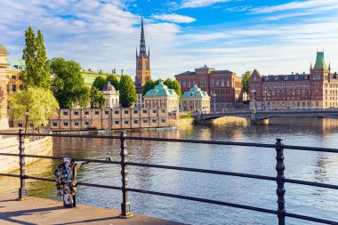 Golden sunset light illuminates the ancient buildings of the city. Wonderful excursion to the Stockholm. Stockholm is the picturesque northern capital of Sweden. Hot summer day