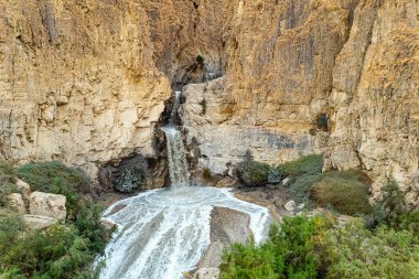 The famous biblical stream Kidron. Winter flood on the Kidron stream before flowing into the Dead Sea. The waterfall and a small lake were photographed by a drone. Cold rainy winter in Israel. 