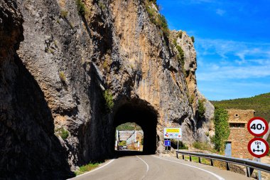 The La Penia Reservoir collects the waters of the Gallego River. La Jolla de Huesca. Picturesque cliffs, tunnel, bridge and still water. Wonderful autumn day. Spain