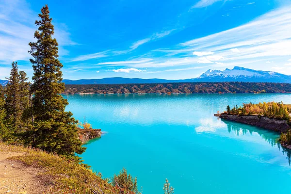 Picturesque Abraham Lake with blue water. Sunny day in October. Gorgeous Canadian autumn. Journey Magical Rocky Mountains
