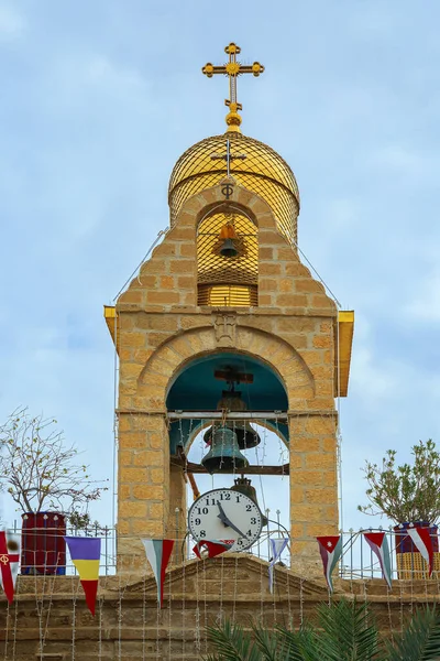Belfry topped with a gilded Orthodox cross. Monastery of St. Gerasim of Jordan. The male monastery of the Jerusalem Orthodox Church in the Judean Desert.