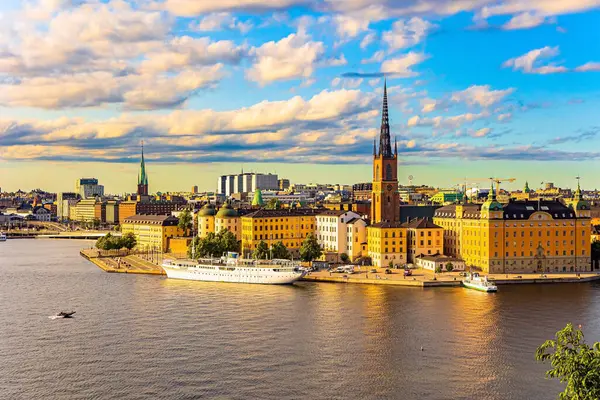 Golden sunset light illuminates the ancient buildings of the city.  Hot summer day in Stockholm. Stockholm is the capital of Sweden.